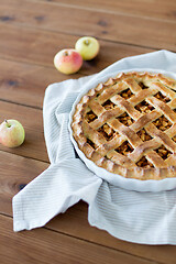 Image showing apple pie in baking mold on wooden table