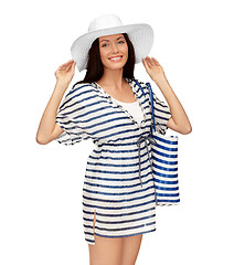 Image showing young woman in striped tunic and sun hat