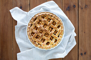 Image showing close up of apple pie in mold on wooden table