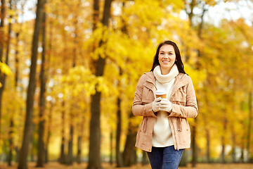 Image showing woman drinking takeaway coffee in autumn park