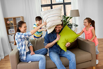 Image showing happy family having pillow fight at home