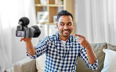 Image showing male video blogger with camera blogging at home