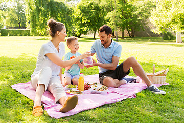 Image showing happy family having picnic at summer park