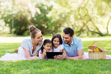 Image showing family with tablet pc on picnic in summer park