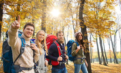 Image showing friends with backpacks hiking in autumn