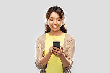 Image showing asian woman in headphones listening to music