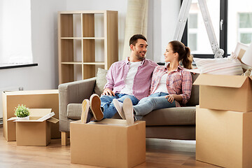 Image showing happy couple with boxes moving to new home