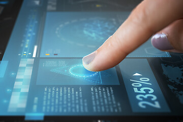 Image showing finger on touch screen with virtual data