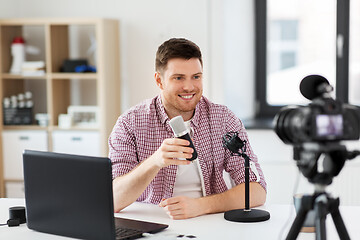 Image showing male blogger with microphone videoblogging