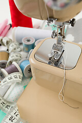 Image showing Sewing machine, fabric and measurement tape