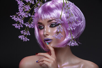 Image showing Beautiful girl in purple wig with flowers