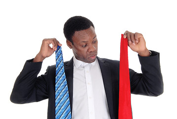 Image showing Man can not decide what necktie to wear