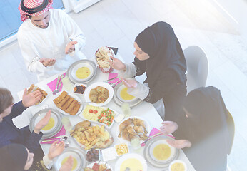 Image showing traditional muslim family praying before iftar dinner