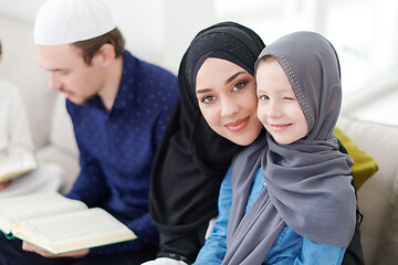 Image showing muslim family reading Quran and praying at home