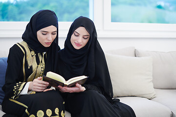 Image showing young muslim women reading Quran at home