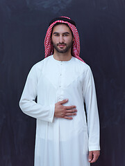 Image showing portrait of arabian man in front of black chalkboard