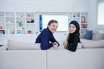 Image showing young muslim couple watching TV together