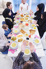 Image showing traditional muslim family praying before iftar dinner