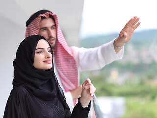 Image showing portrait of beautiful arabian couple standing on balcony