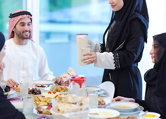 Image showing Muslim family having Iftar dinner drinking water to break feast