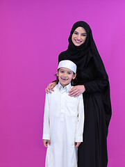 Image showing portrait of muslim mother and son on pink background
