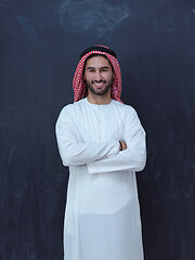 Image showing portrait of arabian man in front of black chalkboard