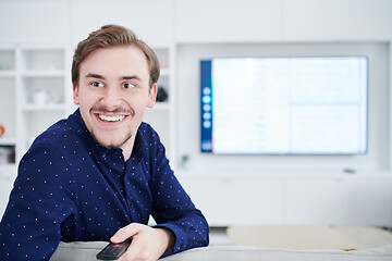 Image showing young man watching tv at big modern home