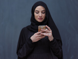 Image showing young modern muslim business woman using smartphone