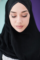 Image showing young modern muslim business woman using smartphone at home