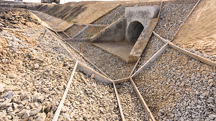 Image showing Construction of a drainage ditch along a road with a culvert under the road