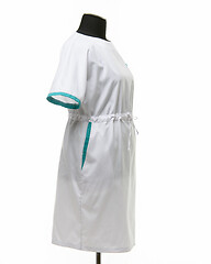 Image showing Side view of a female medical gown on a mannequin for clothes on a white background