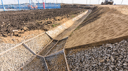 Image showing Strengthening the slope and constructing a drainage ditch along the road