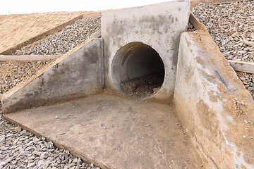 Image showing Installation of culvert drainage pipe and ditch structures under the highway