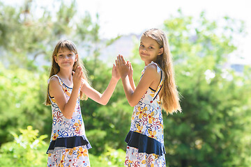 Image showing Children play in the frogs walking in the city park, and looked into the frame