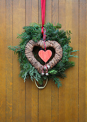 Image showing Traditional christmas wreath on a wooden door