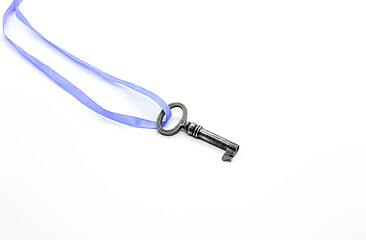 Image showing Vintage silver key on blue ribbon on white background