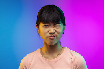 Image showing Asian young woman\'s portrait on gradient studio background in neon