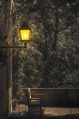 Image showing lonely bench under a lamp by night