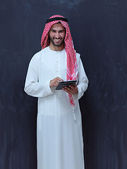 Image showing young arabian muslim businessman using tablet computer