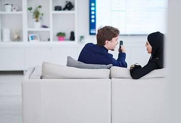 Image showing young muslim couple watching TV together