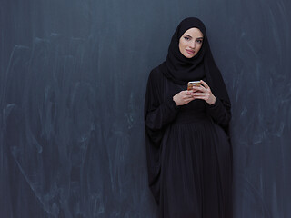 Image showing young modern muslim business woman using smartphone