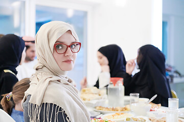 Image showing young muslim woman having Iftar dinner with family
