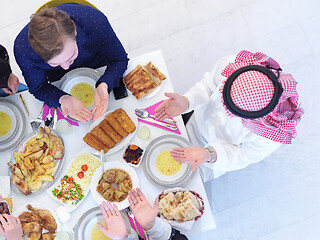 Image showing traditional muslim family praying before iftar dinner