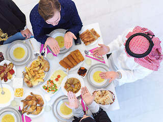 Image showing traditional muslim family praying before iftar dinner