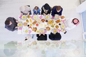 Image showing traditional muslim family praying before iftar dinner top view