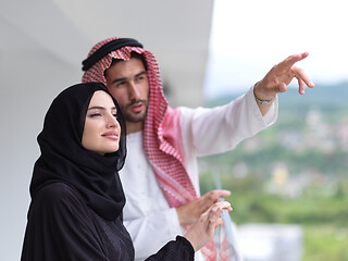 Image showing portrait of beautiful arabian couple standing on balcony