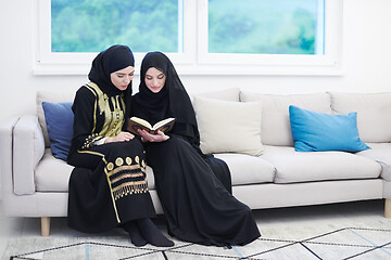 Image showing young muslim women reading Quran at home