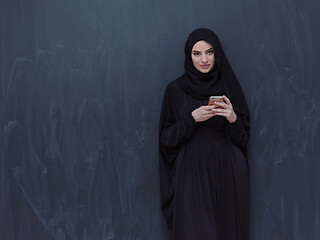 Image showing young modern muslim business woman using smartphone