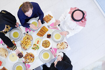 Image showing traditional muslim family praying before iftar dinner top view