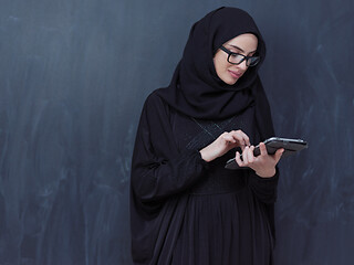 Image showing young muslim business woman using tablet computer